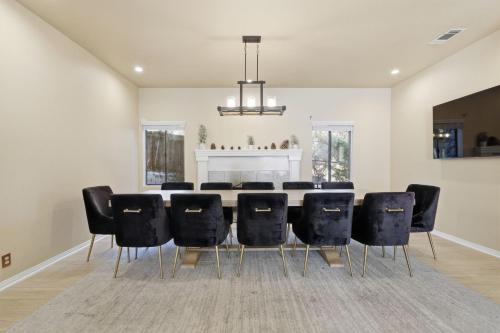 a dining room with a table and black chairs at Spacious Mountain Getaway Game Room & Gazebo villa in Pine Mountain Club