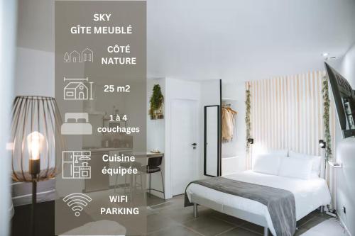 a bedroom with a white bed and a desk at SKY - Gîte meublé & confort Drôme - Écolodgîte in Laveyron