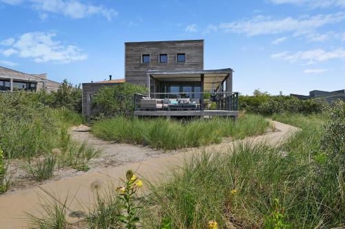 une maison sur la plage avec un chemin de sable dans l'établissement Dune & Lakeview Villa 6p - Luxe, Lounge & Verwarmd Terras - Villa 30, à Ouddorp