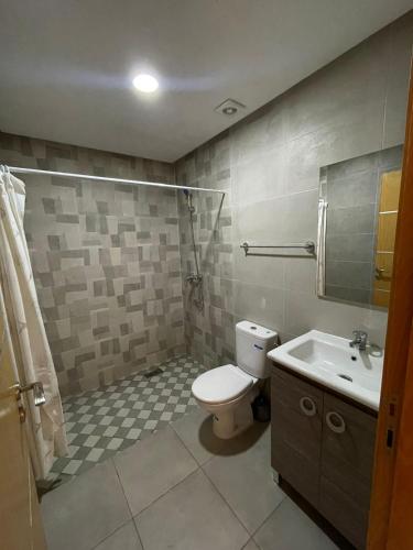 a bathroom with a toilet and a sink at إقامة الرياض الأطلس in Beni Mellal