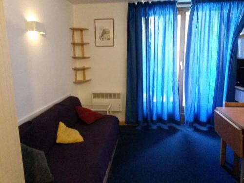 ヴァル・トランスにあるAltineige 4 Pers, Ski-inoutの青いカーテンとソファのあるリビングルーム