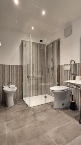 a bathroom with a shower and a toilet and a sink at La Giulia Suites like Home in Bonassola