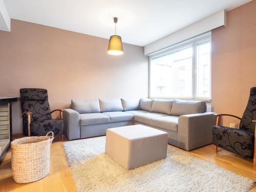 a living room with a couch and a table at Aurora Family Suite in Rovaniemi