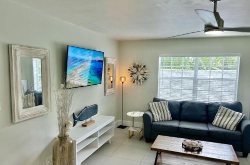 a living room with a couch and a table at Perfect location, close to everything! in West Palm Beach