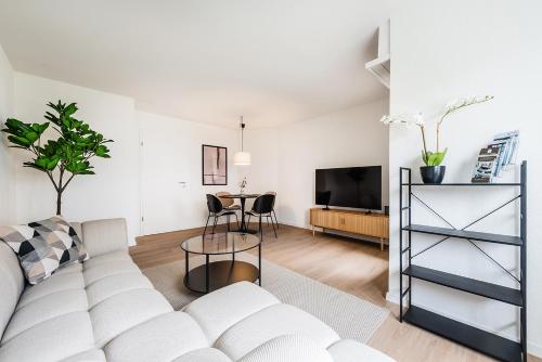 a living room with a white couch and a table at GOLD-APARTMENT 2 !Gratis Parken, Free Parking! in Frauenfeld