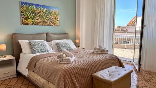 a bedroom with a bed with towels on it at Mondello SunSea in Mondello