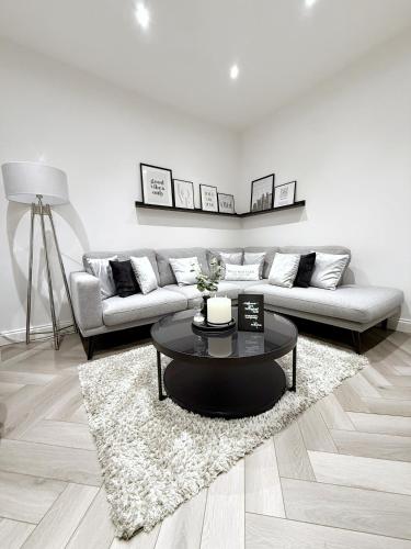 a living room with a couch and a table at A home away from home in Manchester