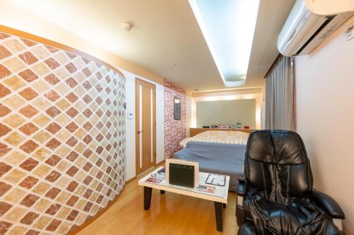 a room with a bed and a desk and a chair at Hotel Mist -Adult Only-CHIBA in Chiba