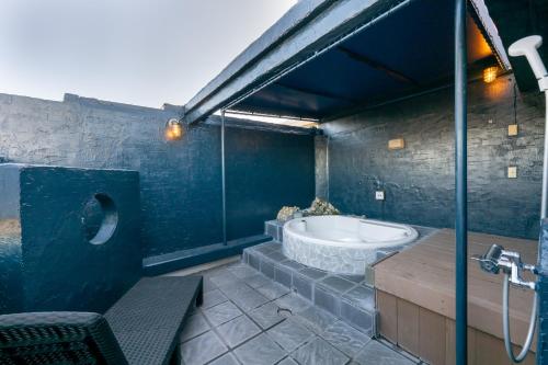 a large bathroom with a tub and a sink at Hotel Mist -Adult Only-CHIBA in Chiba