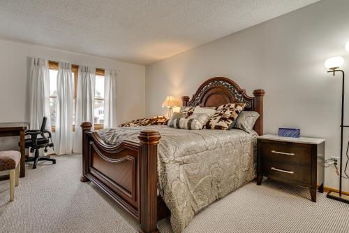 a bedroom with a bed and a desk and a window at 12 Mi to Dtwn St Paul Extended Stay in Woodbury! in Woodbury