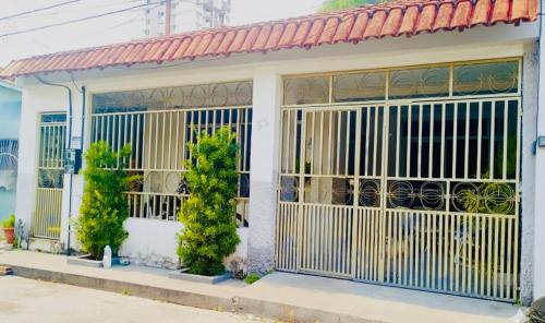 a building with a gate and trees in front of it at Fique no coração de Belém in Belém