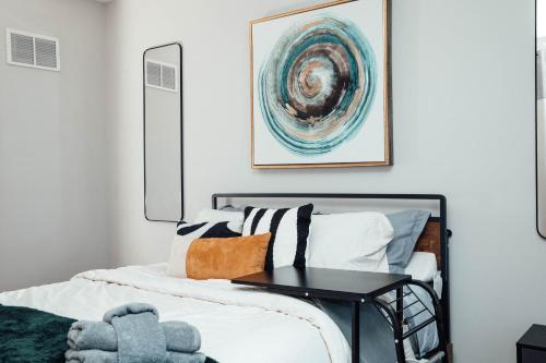 a bedroom with a bed with a table on it at Modern & Spacious Stay by Northwestern Hospital Bronzeville in Chicago