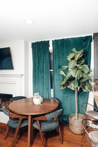 a dining room with a table and a potted plant at Modern & Spacious Stay by Northwestern Hospital Bronzeville in Chicago