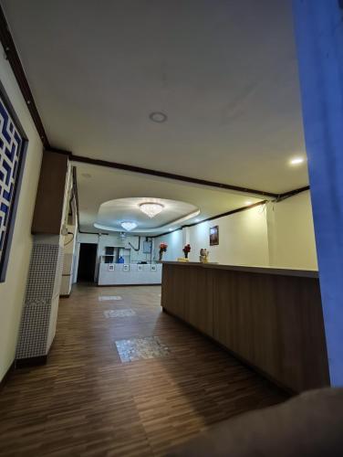 an empty hallway of an office with a reception desk at MAGNIFICo INN PATTAYA in Pattaya