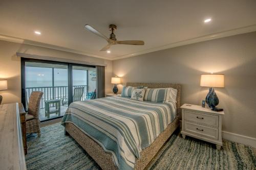 a bedroom with a bed and a balcony at Sand Pointe 137 in Sanibel