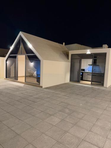 a house with glass doors on top of a roof at ستاي إن Stay Inn in Nizwa