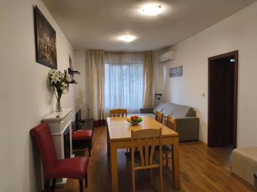 a dining room and living room with a table and chairs at Apartament 4 seasons - Top Lodge in Bansko