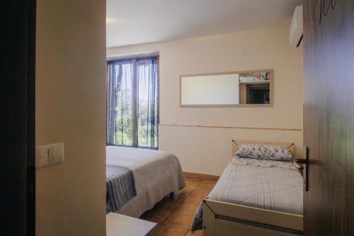 a small bedroom with a bed and a window at Le Margherite in Castiglione del Lago