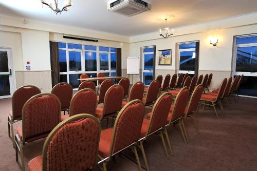 a conference room with a table and chairs at Exeter Court Hotel in Exeter