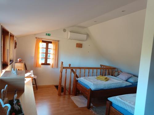 a small bedroom with two beds and a window at Kuća za odmor Laura in Kutina