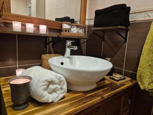 a bathroom with a white sink on a wooden counter at Villa Seven 2 in Dunkerque