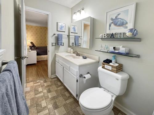 a bathroom with a toilet and a sink at Firepit, Bbq, 30 Min Ft Bragg, Smarttv, King,pets in Vass