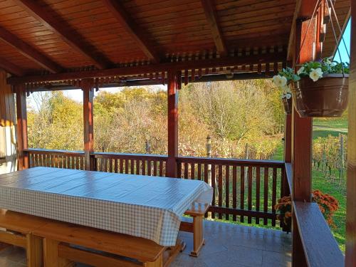 a wooden porch with a mattress on a table on a deck at Kuća za odmor Laura in Kutina