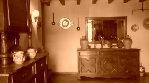 a bathroom with a wooden dresser and a mirror at Casa Rural La Era in Aldeanueva de Barbarroya