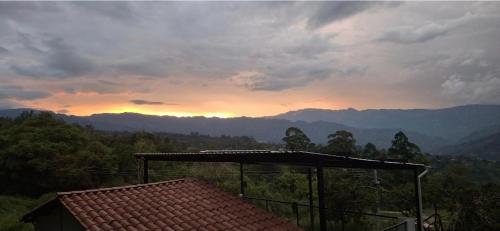a view of a sunset from a roof of a house at Manawa Kaona in Somondoco