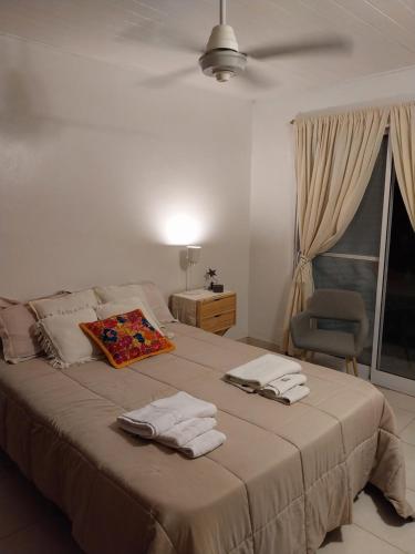 a bedroom with a large bed with towels on it at Felicità in Realicó