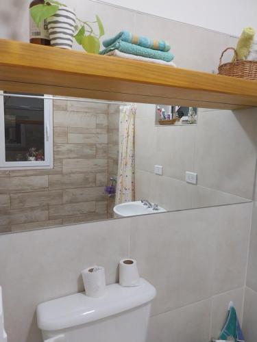 a white bathroom with a toilet and a sink at Felicità in Realicó