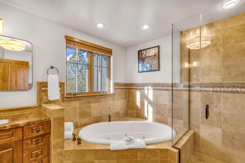 a bathroom with a tub and a glass shower at Upscale 3 BR Townhouse @ Juniper Preserve Resort in Bend