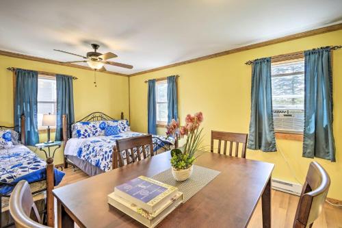 a living room with a table and a bed at Tranquil Trails Cabin & Suites At Equestrian House in Pleasant Mount