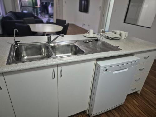 a kitchen with a sink and a counter top at Dalyellup 2BR accommodation-Rear Guest house Unit- Walkable to major supermarkets in North Boyanup