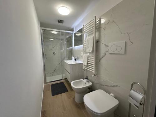 a white bathroom with a toilet and a sink at Residenza Aurea Tivoli in Tivoli