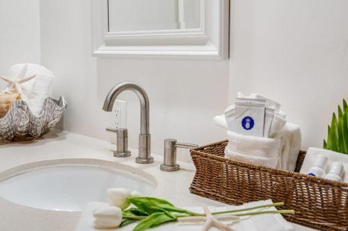 a bathroom counter with a sink with a sink at Lauloa 105 · LOA 105 2BD OceanFront Getaway w AC Pool in Wailuku