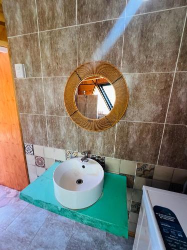 a bathroom with a sink and a mirror at Domo Del Rio in Los Reartes