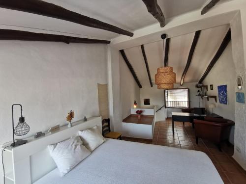 a bedroom with a bed and a living room at Casa ricapaz - Long Term Advantage in Castillo de Locubín