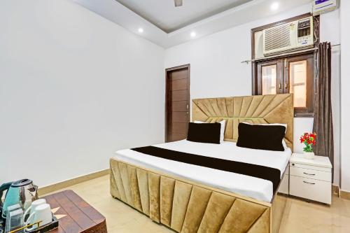 a bedroom with a large bed in a room at Hotel O Yash stay in New Delhi