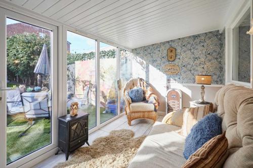 a living room with a couch and chairs and windows at Host & Stay - The Cheeky Squirrel in New Brighton