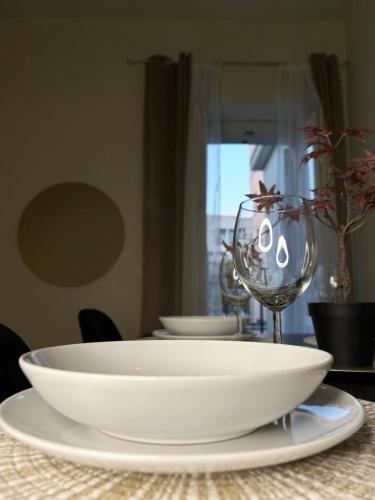 a table with a white bowl and glasses on it at Nido di Rossini in Pesaro