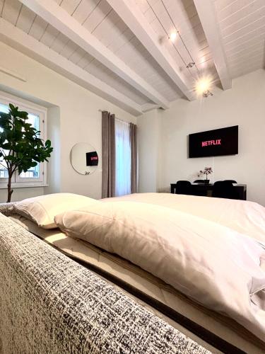 a bedroom with a large bed with a tv on the wall at Nido di Rossini in Pesaro