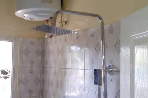 a shower in a bathroom with a shower curtain at 4 Bed House Sleeps 8 - Garden and Pets Welcome in Brikama