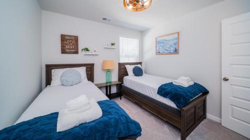 a bedroom with two beds and a window at Golf and Beach Getaway in Sunset Beach