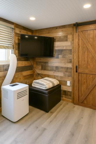 a room with wooden walls and a tv on a wall at Dillon Ave Homes in Cheyenne