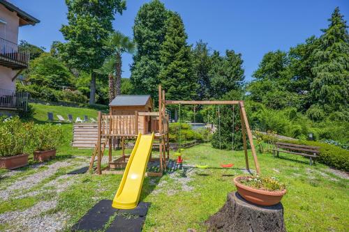 a playground in a yard with a slide at Villa Anna Isole Borromee in Baveno
