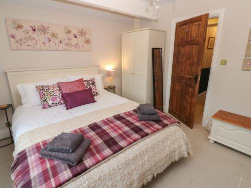 a bedroom with a bed with towels on it at 57 Cockpit Hill in Northallerton