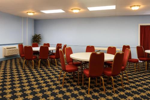 a conference room with tables and red chairs in it at MHO Hotel Dover in Dover