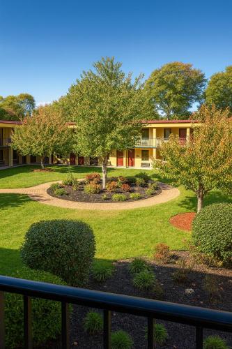 a building with a garden with trees and bushes at MHO Hotel Dover in Dover