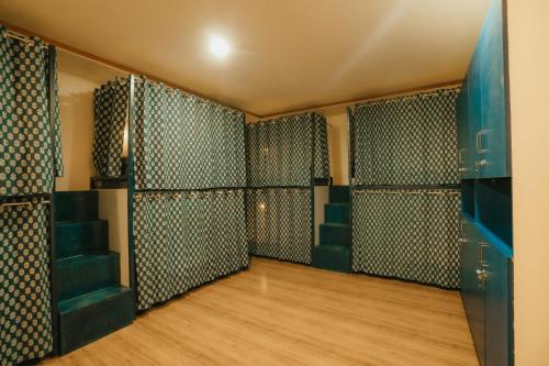 a locker room with green walls and wooden floors at Jai Kutir Homestay - Hawa Mahal View in Jaipur